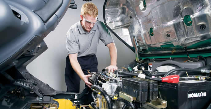 Technician Working on Engine